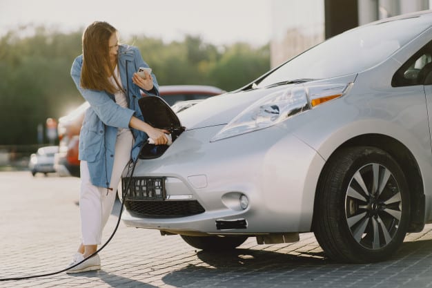 woman-charging-electro-car-electric-gas-station_1157-35440